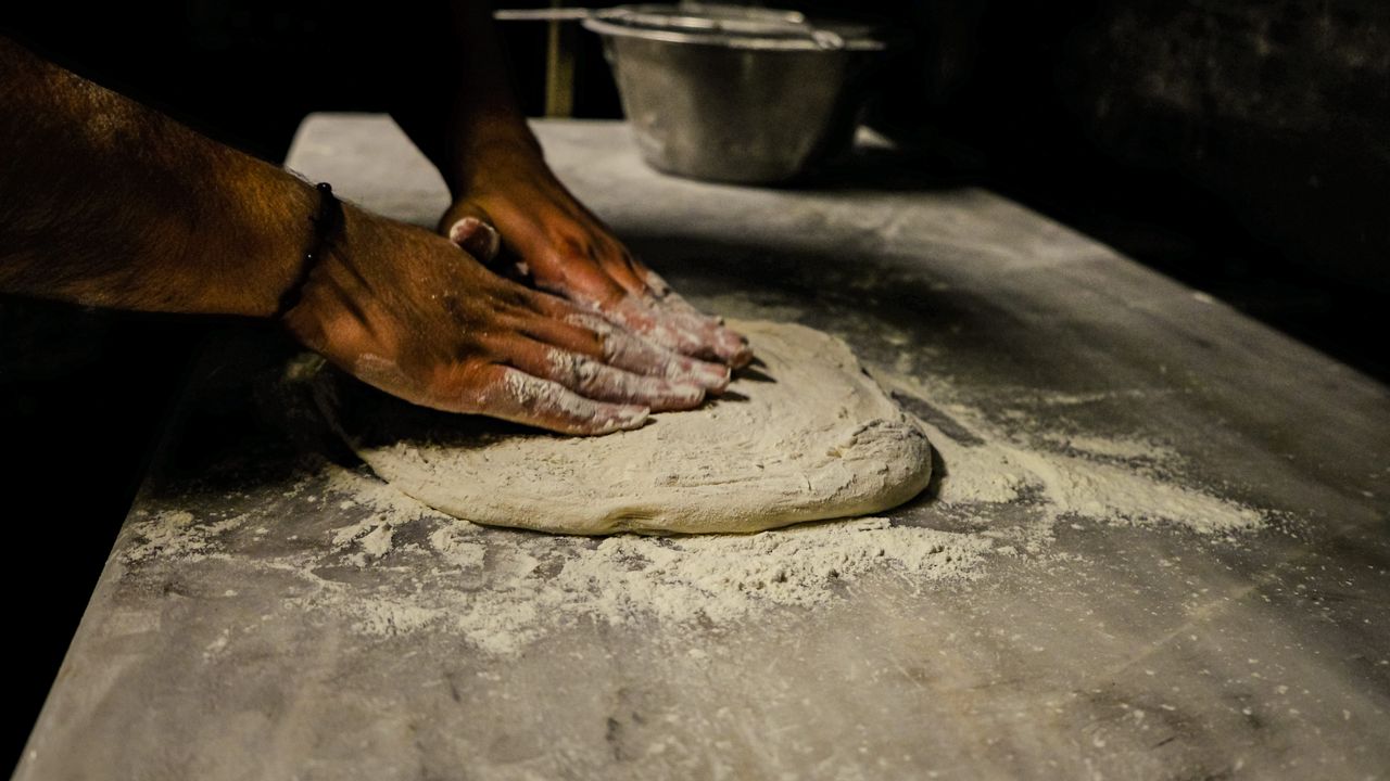 Dough being kneaded by hand